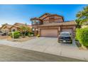 Beautiful two-story home with a three-car garage, tile roof, and well-manicured landscaping at 7246 W Monte Cristo Ave, Peoria, AZ 85382