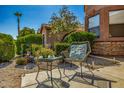 Cozy seating area in the front yard, featuring a table and chairs amidst lush greenery at 7246 W Monte Cristo Ave, Peoria, AZ 85382