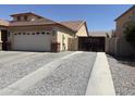 Extended driveway leading to a two-car garage and a gated RV parking area at 9911 W Riverside Ave, Tolleson, AZ 85353