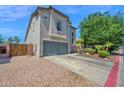 Side view of a beautiful two-story home with gray stucco and a well-maintained front yard at 9918 E Escondido Ave, Mesa, AZ 85208