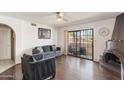 Inviting living room featuring hardwood floors, comfortable furniture, and a sliding glass door to the patio at 10410 N Cave Creek Rd # 2229, Phoenix, AZ 85020