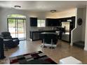 Open-concept kitchen features an island, stainless steel appliances, and modern black cabinetry at 1350 S Greenfield Rd # 1219, Mesa, AZ 85206