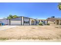 Single-story house featuring an attached two-car garage, manicured bushes, and large picture windows at 14014 N 39Th Ave, Phoenix, AZ 85053
