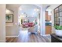Open-concept living room with archways, hardwood floors, and a view to the kitchen at 15953 W Catalina Dr, Goodyear, AZ 85395