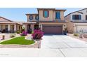Inviting two-story home with a well-kept lawn, concrete driveway, and charming curb appeal at 19461 N Rose Rd, Maricopa, AZ 85138