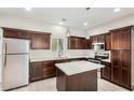 Well-lit kitchen features stainless steel appliances, an island, and dark wood cabinetry at 2000 N 36Th St # 30, Phoenix, AZ 85008
