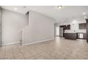 Open-concept living area with tile flooring connects to the staircase and kitchen at 2000 N 36Th St # 30, Phoenix, AZ 85008