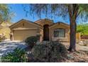 Charming one-story home featuring a 2-car garage and meticulously maintained front yard landscaping at 23682 W Bowker St, Buckeye, AZ 85326