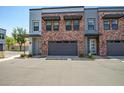 Charming townhome featuring brick accents, private garages, and well-maintained landscaping at 240 W Missouri Ave # 1, Phoenix, AZ 85013