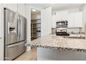 Modern kitchen featuring stainless steel appliances, granite countertops, and ample storage space in the pantry at 25876 N 162Nd Dr, Surprise, AZ 85387