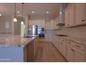 Beautiful kitchen featuring white cabinets, stainless steel appliances, and an island with granite countertops at 2811 S Jeffry St, Gilbert, AZ 85295