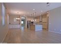 Open-concept living space featuring wood-look tile floors, recessed lighting, and a kitchen with white cabinets at 2811 S Jeffry St, Gilbert, AZ 85295