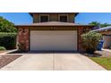 Charming home featuring a brick-accented garage and extended driveway at 3705 W Villa Theresa Dr, Glendale, AZ 85308