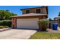 Charming home featuring a brick-accented garage and extended driveway with fresh landscaping at 3705 W Villa Theresa Dr, Glendale, AZ 85308