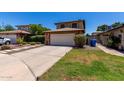 Charming home featuring a brick-accented garage and extended driveway with fresh landscaping at 3705 W Villa Theresa Dr, Glendale, AZ 85308