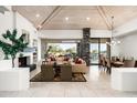 Bright living room featuring a fireplace, high wood ceilings, and seamless indoor-outdoor living at 39089 N 102Nd Way, Scottsdale, AZ 85262