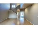 Bright living room with vaulted ceiling, hardwood floors and staircase at 4776 W Eva St, Glendale, AZ 85302