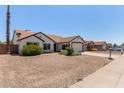 Lovely single-story home boasting desert landscaping, a two-car garage, and a welcoming entrance at 10807 W Morten Ave, Glendale, AZ 85307