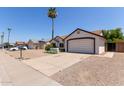 A well kept single story home featuring desert landscaping and a two-car garage at 10807 W Morten Ave, Glendale, AZ 85307