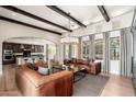 Spacious living room featuring exposed beams, hardwood floors, and an open floor plan at 11070 E Bent Tree Dr, Scottsdale, AZ 85262