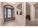 View of the foyer showing a decorative glass door, and an arched doorway to another room at 12710 W Forest Pleasant Pl, Peoria, AZ 85383