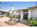 Inviting front exterior with brick pathway, desert landscaping, and security system at 1441 E Hubbell St, Phoenix, AZ 85006
