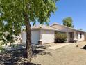 Inviting single-story home with a two-car garage, desert landscaping, and a charming front entrance at 15706 W Young St, Surprise, AZ 85374