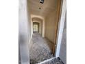 Under construction view of a hallway with an arched doorway and unfinished walls and floors at 18751 W Monterosa St, Litchfield Park, AZ 85340