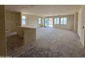 Unfinished large living room with multiple windows and sliding glass door leading to the backyard at 18751 W Monterosa St, Litchfield Park, AZ 85340