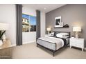 Bedroom with a neutral color palette, large window, cozy carpet, and modern furnishings at 22673 E San Tan Blvd, Queen Creek, AZ 85142
