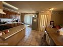 Functional kitchen with a breakfast bar, ample cabinet space, and a cozy dining area for Gathering meals at 3937 W Stella Ln, Phoenix, AZ 85019