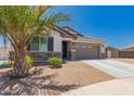 Inviting single-story home with desert landscaping, stone veneer accents and a convenient two-car garage at 40913 W Williams Way, Maricopa, AZ 85138