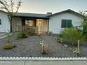 Charming single story home with gravel landscaping and a decorative white border at 433 S 113Th Pl, Mesa, AZ 85208