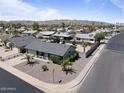 An aerial view of a well-maintained single-story home with desert landscaping and a spacious backyard at 6802 S 44Th Pl, Phoenix, AZ 85042