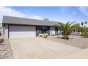 Well-maintained single-story home with a spacious driveway and a xeriscaped front yard at 6802 S 44Th Pl, Phoenix, AZ 85042