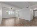 Spacious living room with tiled floors, white brick accents, and natural light at 8211 E Garfield St # J219, Scottsdale, AZ 85257