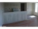 A living room and kitchen space with fresh paint, updated flooring, and modern fixtures at 8838 N 8Th St # 105, Phoenix, AZ 85020