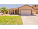 Inviting single-story home with a well-kept lawn and a cozy front porch at 888 S 165Th Ln, Goodyear, AZ 85338