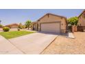 Beige single-story home featuring a two-car garage and wide driveway at 888 S 165Th Ln, Goodyear, AZ 85338
