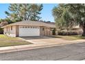 Attractive home showcasing a well-manicured lawn and a spacious two-car garage at 10205 W Royal Oak Rd, Sun City, AZ 85351