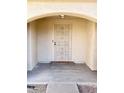 Close-up of the front door, which features a secure metal security screen door, set into an arched entryway at 1249 E Commerce Ave, Gilbert, AZ 85234