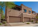 A view of townhouses featuring attached garages, and a stylish design with balconies and stucco exterior at 13600 N Fountain Hills Blvd # 501, Fountain Hills, AZ 85268