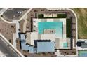Birds-eye-view of a resort-style community pool with lounge chairs, umbrellas and shade canopies at 15872 W Miami St, Goodyear, AZ 85338