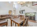 Open-concept living and dining area with staircase, high ceilings, neutral walls and flooring at 16136 W Durango St, Goodyear, AZ 85338