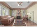 Cozy living room with a decorative fireplace, hardwood floors, and unique vintage touches at 1813 E Willetta St, Phoenix, AZ 85006