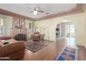 Spacious living room featuring a fireplace, hardwood flooring, and an arched doorway at 1813 E Willetta St, Phoenix, AZ 85006