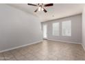 Open-concept living room with tile floors, fan, and multiple windows for natural light at 2000 N 36Th St # 10, Phoenix, AZ 85008