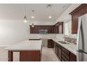 Bright and spacious kitchen with stainless steel appliances, dark wood cabinets and quartz countertops at 2000 N 36Th St # 41, Phoenix, AZ 85008