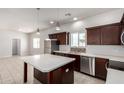 Stylish kitchen island with stainless steel appliances and pendant lighting at 2000 N 36Th St # 8, Phoenix, AZ 85008