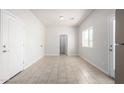 Bright living room with neutral tile flooring and a doorway to another room at 2000 N 36Th St # 8, Phoenix, AZ 85008